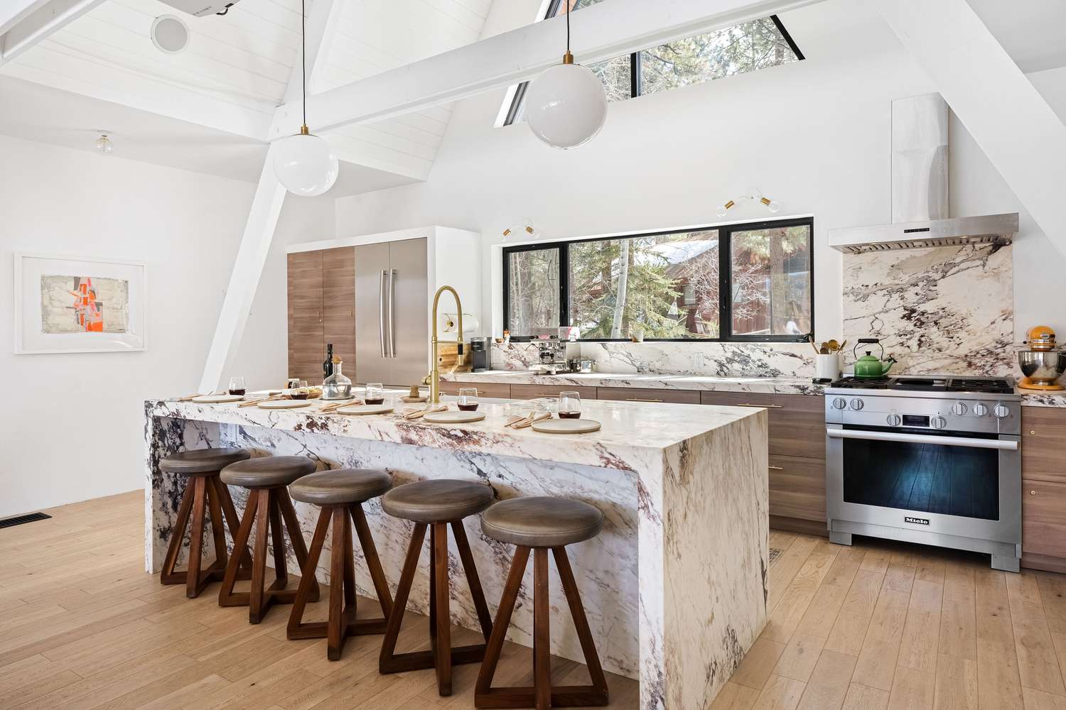 Contemporary kitchen with marble waterfall island